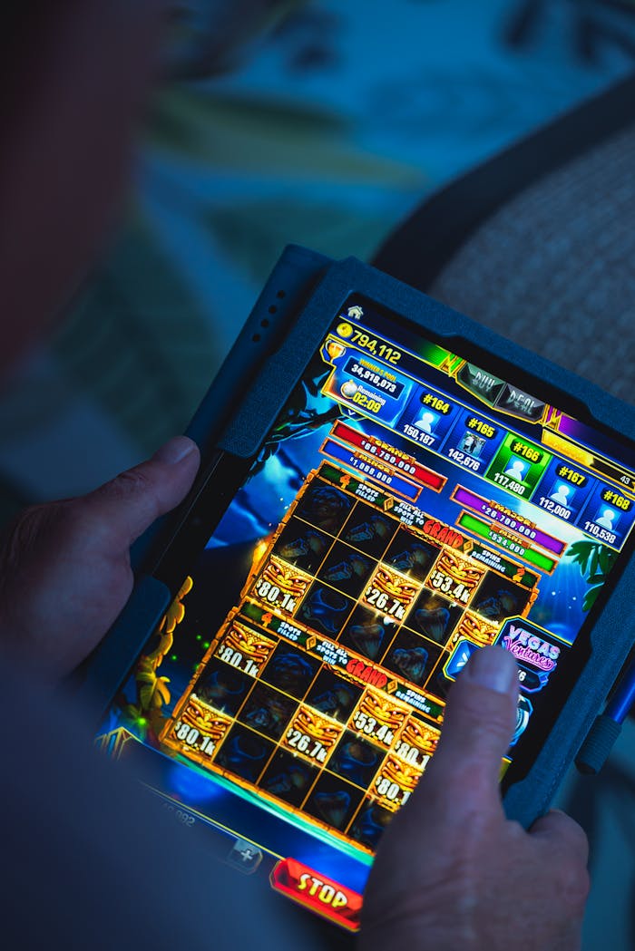 about-me-01 Person playing a mobile gaming app on a tablet, focused on fun and entertainment.