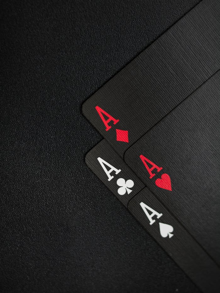 social-feed-img-02 Close-up of four aces on a black background, ideal for casino-themed content.